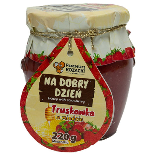 Honig mit Erdbeeren von Kozacki Beeberry, 220g, in einem Glas, zeigt die Kombination aus Honig und frischen Erdbeeren.